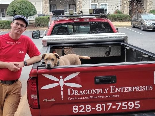 Keller beside a pick-up truck; utility vehicle of Dragonfly Enterprises